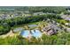 Aerial view of community amenities featuring a pool, clubhouse, tennis courts and a verdant green space at 417 Brier Knob Dr, Fort Mill, SC 29715