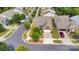Aerial view of a charming home with a well-manicured lawn, a two-car garage, and a lovely landscaped front yard at 417 Brier Knob Dr, Fort Mill, SC 29715