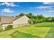 Spacious backyard with lush lawn, mature trees, and an iron fence at 417 Brier Knob Dr, Fort Mill, SC 29715