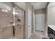 Bathroom showcasing a glass-enclosed shower with a built-in bench, and neutral ceramic tile at 417 Brier Knob Dr, Fort Mill, SC 29715