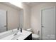 Bathroom featuring a white sink and toilet, illuminated by bright lighting at 417 Brier Knob Dr, Fort Mill, SC 29715