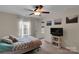 Bright bedroom with a ceiling fan, plush bed, and a modern TV stand at 417 Brier Knob Dr, Fort Mill, SC 29715