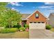 Charming brick front home features a well-manicured lawn, inviting entrance, and an attached two-car garage at 417 Brier Knob Dr, Fort Mill, SC 29715