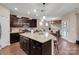 A kitchen featuring an island with granite countertops and dark wood cabinets at 417 Brier Knob Dr, Fort Mill, SC 29715