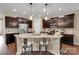 A kitchen featuring an island with granite countertops, stainless steel appliances, and dark wood cabinets at 417 Brier Knob Dr, Fort Mill, SC 29715