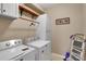 Efficient laundry room setup with modern washer and dryer, storage cabinets, and a 'Fluff & Fold' decorative sign at 417 Brier Knob Dr, Fort Mill, SC 29715