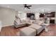 Spacious living room open to kitchen featuring a comfortable sectional, hardwood floors, and abundant natural light at 417 Brier Knob Dr, Fort Mill, SC 29715