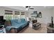 Comfortable living room area with large windows, ceiling fan, and relaxing furniture at 417 Brier Knob Dr, Fort Mill, SC 29715