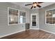 A cozy sunroom is surrounded by windows and features wood grain floors and a ceiling fan at 417 Brier Knob Dr, Fort Mill, SC 29715