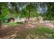 Large and private backyard with mature trees, a shed, and a patio set for outdoor relaxation at 418 Melody Ln, Shelby, NC 28152
