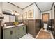 Stylish bathroom featuring a double sink vanity, modern lighting, and wainscoting at 418 Melody Ln, Shelby, NC 28152