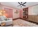 Bright bedroom featuring a built-in bookcase, comfortable chair, and stylish decor at 418 Melody Ln, Shelby, NC 28152