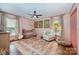 Charming Bedroom with pink walls, floral rug, crib, and lots of natural light at 418 Melody Ln, Shelby, NC 28152