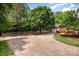 Long driveway leading to a charming home with mature trees and a well-manicured lawn at 418 Melody Ln, Shelby, NC 28152