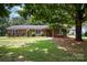 Charming brick home with a well-maintained lawn and mature trees in a peaceful neighborhood at 418 Melody Ln, Shelby, NC 28152