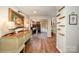 Hallway featuring hardwood flooring, a decorative sideboard, and a view towards the breakfast nook and kitchen at 418 Melody Ln, Shelby, NC 28152