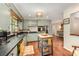 Spacious kitchen boasting green cabinets, stainless steel appliances, an island, and hardwood flooring throughout at 418 Melody Ln, Shelby, NC 28152