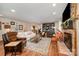 Open-concept living room featuring a fireplace, hardwood floors, and stylish decor at 418 Melody Ln, Shelby, NC 28152
