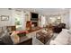 Bright living room featuring a brick fireplace, hardwood floors, and large windows for natural light at 418 Melody Ln, Shelby, NC 28152