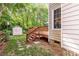 Backyard featuring a wooden deck, an outdoor umbrella, and a small storage shed at 4333 Poplar Grove Dr, Charlotte, NC 28269