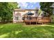 Expansive backyard featuring a deck, lush green lawn, and mature trees for outdoor enjoyment at 4333 Poplar Grove Dr, Charlotte, NC 28269