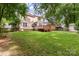 Wide-open backyard with a wooden deck, a well-manicured lawn, and a shed at 4333 Poplar Grove Dr, Charlotte, NC 28269