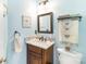 Bathroom with marble vanity, framed mirror, blue walls, and decorative fixtures at 4333 Poplar Grove Dr, Charlotte, NC 28269