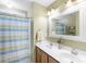 Bathroom featuring a double vanity, large mirror, and shower with striped curtain at 4333 Poplar Grove Dr, Charlotte, NC 28269