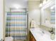 Bathroom featuring a single vanity, large mirror, shower with striped curtain and toilet at 4333 Poplar Grove Dr, Charlotte, NC 28269