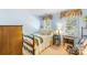 Cozy bedroom with light blue walls, two windows, and a patterned bedspread at 4333 Poplar Grove Dr, Charlotte, NC 28269