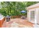Outdoor deck with a grill and table with an umbrella for relaxing and entertaining at 4333 Poplar Grove Dr, Charlotte, NC 28269
