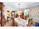 Dining room with natural light, floral wallpaper, and ornate chandelier lighting fixture at 4333 Poplar Grove Dr, Charlotte, NC 28269
