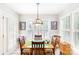 Dining room with natural light, hardwood table, shutters and pendant lighting fixture at 4333 Poplar Grove Dr, Charlotte, NC 28269