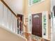Inviting foyer featuring hardwood floors, a staircase, and a stylish front door with sidelights at 4333 Poplar Grove Dr, Charlotte, NC 28269