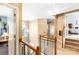 Bright hallway featuring hardwood railing, staircase, chandelier, and multiple doorways at 4333 Poplar Grove Dr, Charlotte, NC 28269