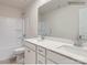Bathroom featuring double vanity sinks, white cabinetry, and shower-tub combo at 4404 Dusty Orchard Rd, Kannapolis, NC 28081