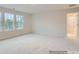 Spacious bedroom with three windows, neutral carpet, and a view to the backyard at 4404 Dusty Orchard Rd, Kannapolis, NC 28081