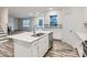 Bright kitchen featuring an island sink, white cabinetry, and stainless steel appliances at 4404 Dusty Orchard Rd, Kannapolis, NC 28081