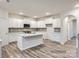 Open concept kitchen with a large island, white cabinets, and modern appliances at 4404 Dusty Orchard Rd, Kannapolis, NC 28081