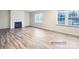 Bright living room featuring luxury vinyl plank flooring and a gas fireplace at 4404 Dusty Orchard Rd, Kannapolis, NC 28081