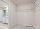 Walk-in closet with wire shelving and a doorway leading to an adjoining bathroom at 4404 Dusty Orchard Rd, Kannapolis, NC 28081