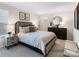 Comfortable bedroom featuring a large bed, stylish decor, neutral tones, and lots of natural light at 4415 Dusty Orchard Rd, Kannapolis, NC 28081