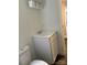 Bathroom featuring white vanity and toilet, with updated lighting and an open door at 4417 Grier St, Gastonia, NC 28056
