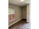 Small bedroom with neutral paint, base molding, wood look floors and a window at 4417 Grier St, Gastonia, NC 28056