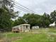 Mobile home on a fenced lot with mature trees and a shed in the back yard at 4417 Grier St, Gastonia, NC 28056