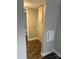 Hallway featuring wood grain vinyl flooring and a utility closet with washer/dryer hookups at 4417 Grier St, Gastonia, NC 28056