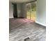 Spacious living room featuring plank flooring, sliding glass doors, and neutral paint at 4417 Grier St, Gastonia, NC 28056
