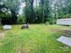 The spacious backyard features lush greenery, a shed, and ample room for outdoor activities at 4524 Cinderella Rd, Charlotte, NC 28213