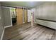 Bedroom featuring stylish barn doors, a dresser, and new flooring for a contemporary feel at 4524 Cinderella Rd, Charlotte, NC 28213