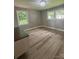 Bedroom featuring hardwood floors, two windows providing natural light, and neutral wall paint at 4524 Cinderella Rd, Charlotte, NC 28213